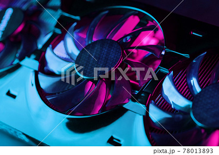 Gaming graphics card with neon magenta-cyan illumination and high-speed fans. Gaming graphics card with neon magenta-cyan illumination and high-speed fans. 78013893