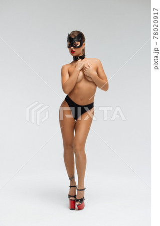 Sexy topless woman in black mask 78020917