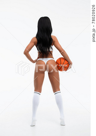 Anonymous sensual woman in white lingerie with basketball in studio Anonymous sensual woman in white lingerie with basketball in studio 78020926
