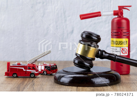 Crime and law - miniature fire car, fire extinguishers and gavel 78024371