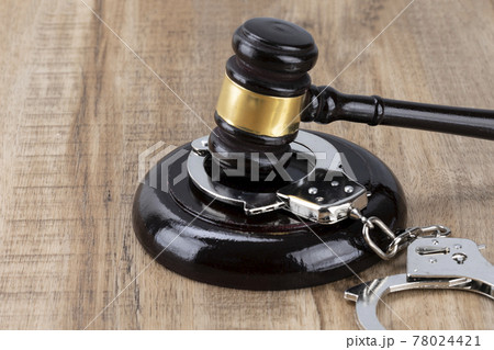 Crime and law - handcuffs and gavel Crime and law - handcuffs and gavel 78024421
