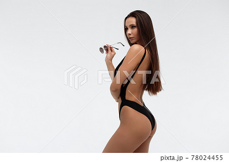 Sexy slim model in stylish black swimsuit 78024455