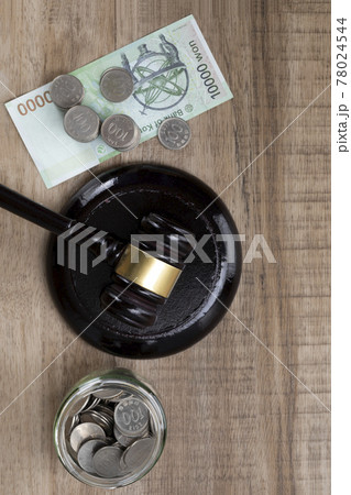 Crime and law - glass bottles filled with coins Banknote and gavel 78024544