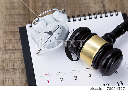 Crime and law-Desktop calendar and alarm clock and gavel 78024597