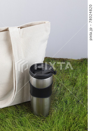 Zero Waste - eco bag and tumbler on grass 78024820