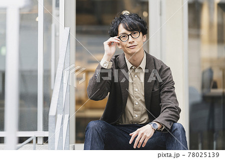 カメラ目線で笑顔の眼鏡をかけた30代男性　ポートレート 78025139