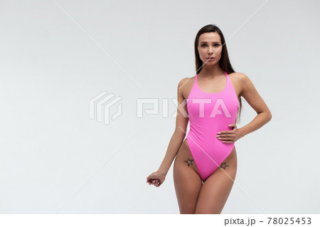 Slim woman in swimwear with sunglasses Slim woman in swimwear with sunglasses 78025453