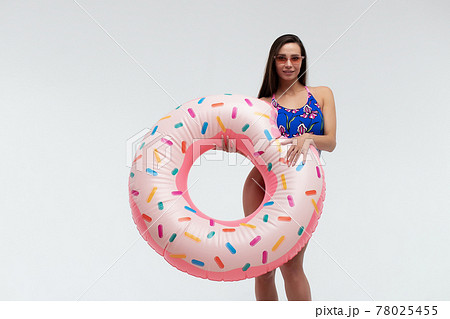 Seductive woman in swimwear with inflatable ring Seductive woman in swimwear with inflatable ring 78025455