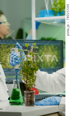 Biologist scientist talking solution from medical flask 78025590