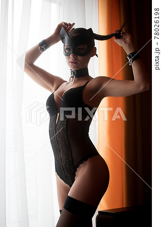 Brunette girl in a cat mask 78026198