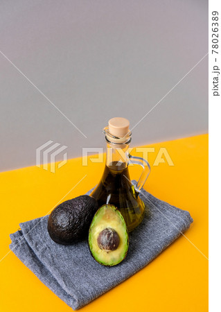Pitcher of natural oil and fresh ripe hass avocados. Preparing food in the kitchen. Ingredients. Concept of healthy food. Minimalistic concept in isometric style in trendy colors. 78026389