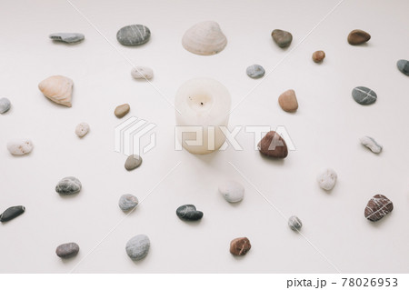 White candle and sea shells pattern on white background. Spa concept. Flat lay, top view White candle and sea shells pattern on white background. Spa concept. Flat lay, top view 78026953