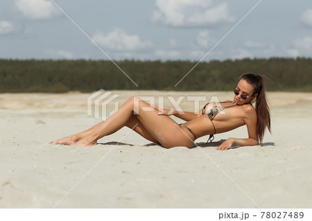 Seductive female resting on beach 78027489