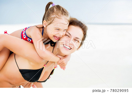 Happy mother and daughter on the ocean beach on Maldives at summer vacation 78029095