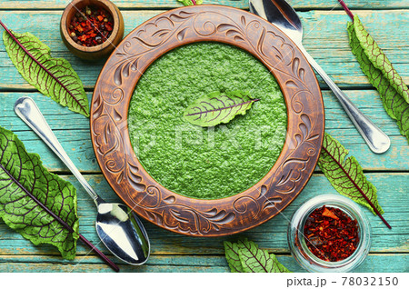 Green soup with sorrel in rustic plate 78032150