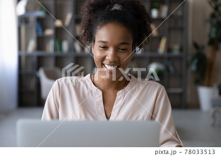 Happy millennial african american businesswoman working on computer. 78033513