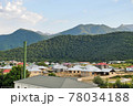 Houses at the foot of Caucasus Mountain range with peak snow background in Gebele, Gabala Azerbaijan  78034188