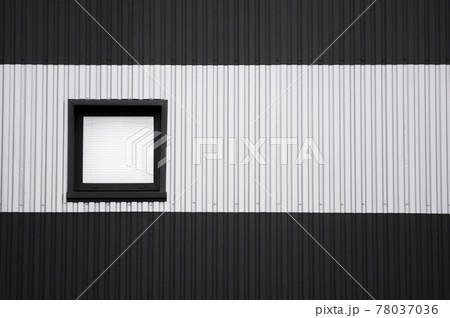 Black and white corrugated iron sheet used as a facade of a warehouse or factory with a window. Texture of a seamless corrugated zinc sheet metal aluminum facade. Architecture. Metal texture. 78037036