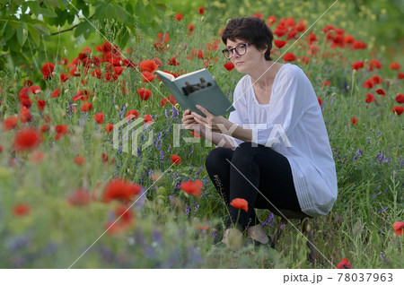 Woman In A Poppy Field Reading A Book 78037963