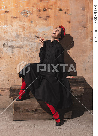Portrait of young woman in the image of a famous artist, personality on vintage background. Retro style, comparison of eras concept. Portrait of young woman in the image of a famous artist, personality on vintage background. Retro style, comparison of eras concept. 78039334