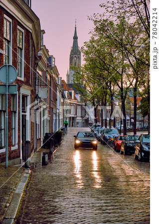 Delft cobblestone street with car in the rain Delft cobblestone street with car in the rain 78042214