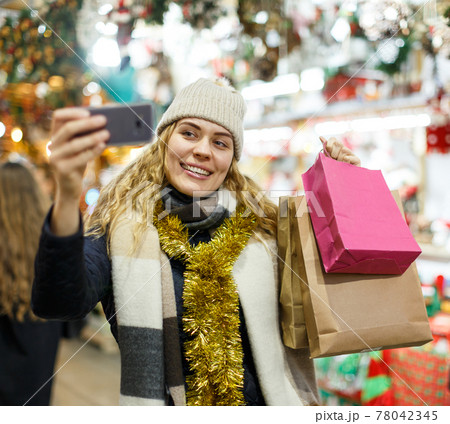Girl taking selfie at Christmas fair Girl taking selfie at Christmas fair 78042345