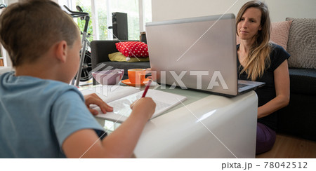 Tired young mother working from home while also homeschooling her son Tired young mother working from home while also homeschooling her son 78042512