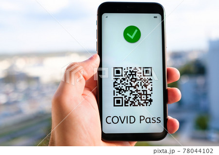 Covid pass with QR code on the screen in smartphone in mans hand on the background of cityscape, May 2021, San Francisco, USA. 78044102