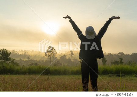 A backpacker tourist woman stretching exercise in morning, traveling at savannah mountain with fog mist at Thung Salaeng Luang National Park, Thailand. Nature landscape. People lifestyle. Relax A backpacker tourist woman stretching exercise in morning, traveling at savannah mountain with fog mist at Thung Salaeng Luang National Park, Thailand. Nature landscape. People lifestyle. Relax 78044137