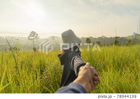 A backpacker Asian tourist woman traveling, walking, holding a boyfriend hand in forest trees at national park. Nature landscape. People lifestyle adventure. Relax A backpacker Asian tourist woman traveling, walking, holding a boyfriend hand in forest trees at national park. Nature landscape. People lifestyle adventure. Relax 78044139