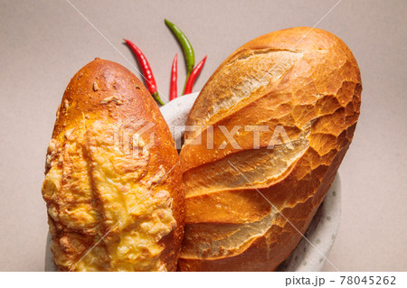 Close-up of fresh bread with pepper and tomato. Fresh bakery. 78045262