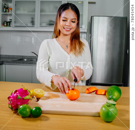 Asian girl cooking healthy vegetarian and vegan food, vegetables and fruits in the kitchen, healthy 78045454