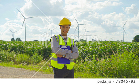 Portrait of Asian windmill engineer man, worker smiling, working on site at wind turbines field or farm, renewable clean energy source. Eco technology for electric power. industry environment. People Portrait of Asian windmill engineer man, worker smiling, working on site at wind turbines field or farm, renewable clean energy source. Eco technology for electric power. industry environment. People 78045793