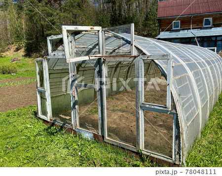 home glass greenhouse standing on the site, made by hands home glass greenhouse standing on the site, made by hands 78048111