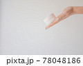 Plastic jar of cream in a female hand isolated on white. Professional cosmetics to restore skin youth, anti-aging cream. Skin care concept. Jar mockup. 78048186