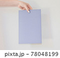 Colored cardboard with an announcement in the hand of a young girl with interesting and important information. card for the inscription. 78048199