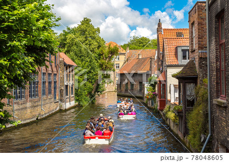 Tourist boat on canal in Bruges 78048605