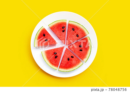 Watermelon slices in white plate on yellow background. Watermelon slices in white plate on yellow background. 78048756