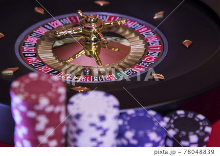 Roulette wheel running in a casino, Poker Chips Roulette wheel running in a casino, Poker Chips 78048839