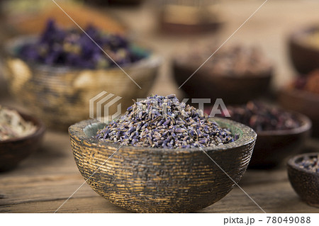 Natural remedy and mortar, healing herbs background Natural remedy and mortar, healing herbs background 78049088