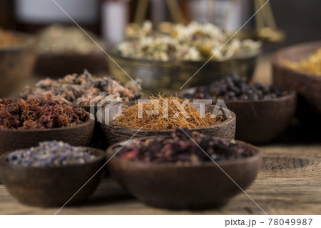 Natural remedy and wooden table background Natural remedy and wooden table background 78049987