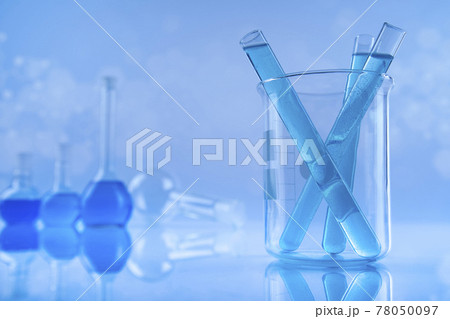 Laboratory beakers, microscope, blue background Laboratory beakers, microscope, blue background 78050097