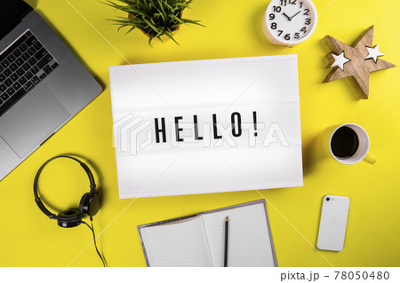 Lightbox with message HELLO on yellow workspace background, start study business Lightbox with message HELLO on yellow workspace background, start study business 78050480