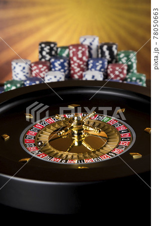 Poker Chips, Roulette wheel in motion, casino background Poker Chips, Roulette wheel in motion, casino background 78050663
