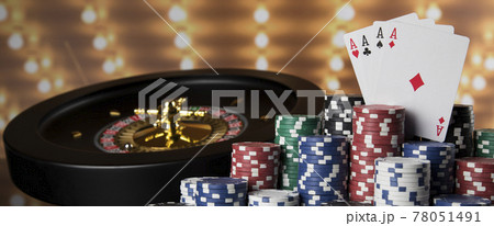 Poker Chips on gaming table, roulette wheel in motion, casino background 78051491