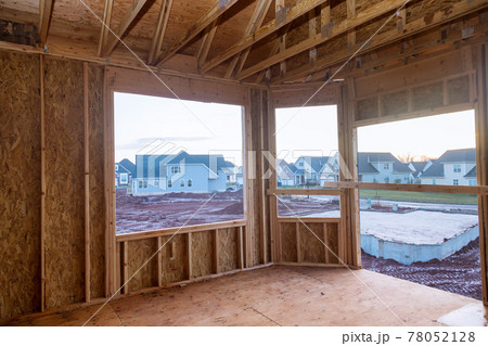 Interior wood framework of new residential home under construction Interior wood framework of new residential home under construction 78052128
