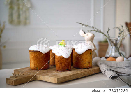 Preparing for Holly holiday. Waist up portrait of happy family showing just baked delicious Easter Preparing for Holly holiday. Waist up portrait of happy family showing just baked delicious Easter 78052286