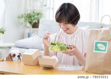 デリバリーで注文した料理を食べる女性 デリバリーで注文した料理を食べる女性 78055031