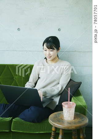 Asian woman sitting sofa. working at home 78057701