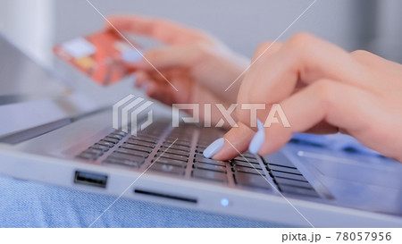 Online shopping - woman hands using laptop computer keyboard and credit card for 78057956